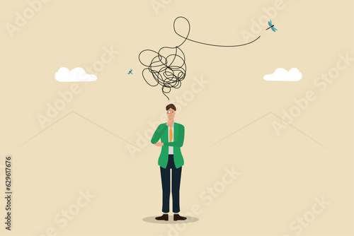 Individual thinking about complex problems, solving problems and unraveling mental knots, concept of confusion or business problem, business man standing with a rope of thoughts