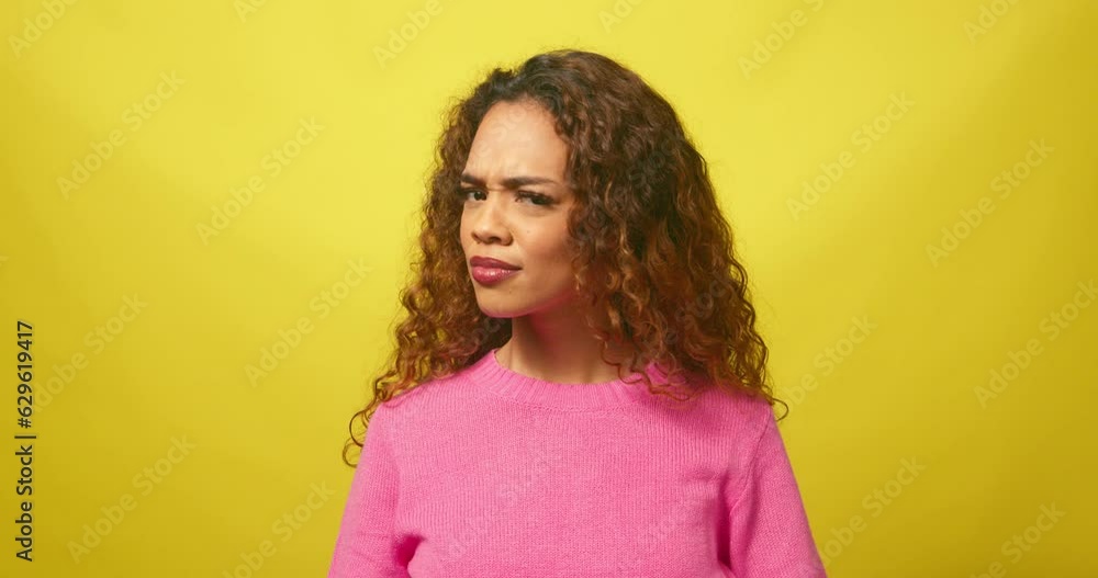Beautiful strong woman gestures No, shakes head, yellow studio background Beautiful strong woman gestures No, shakes head, yellow studio background
