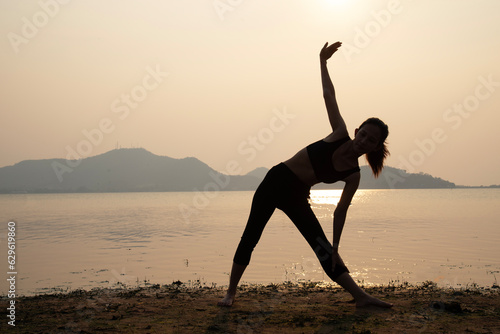 Young woman practicing yoga during luxury yoga retreat in Asia  meditation  relaxation  exercise