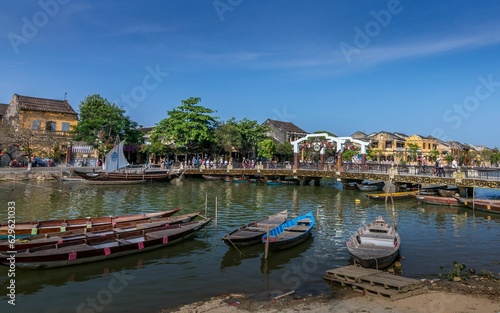 Wallpaper Mural several boats are tied up on a river bank near a bridge and houses Torontodigital.ca