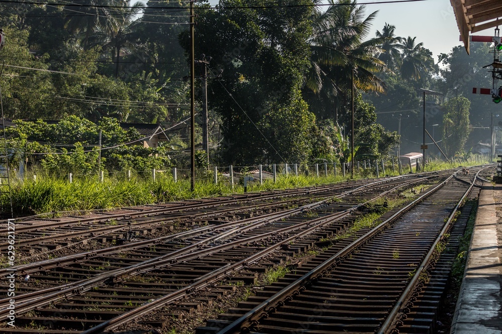 Naklejka premium view down the track to the train station at sunset time