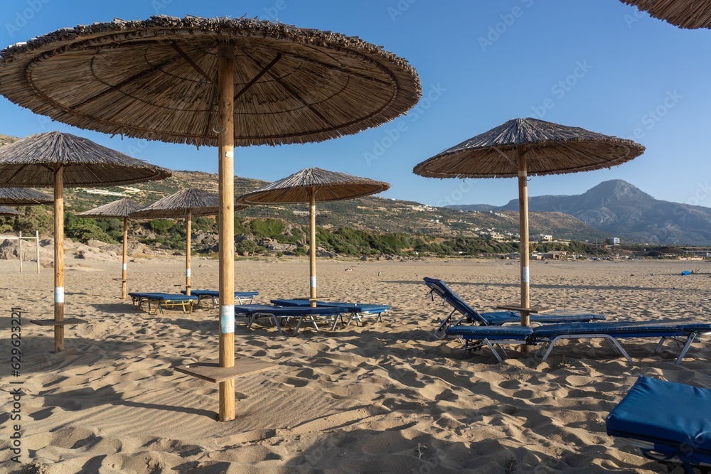 Beach on the Greek island of Crete featuring umbrellas and chairs in the sand