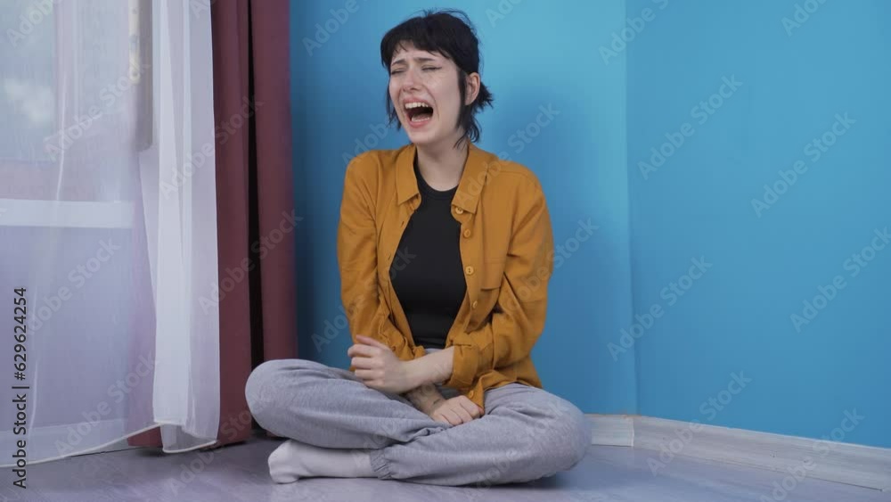 The screaming young woman is crying. Hysterics. The screaming young woman is crying. Hysterics.