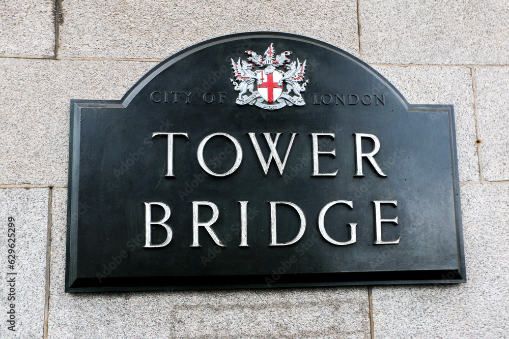 Obraz premium Tower Bridge Sign Plaque with the City of London logo and coat of arms, on the wall of the iconic bridge, signage of famous London attraction