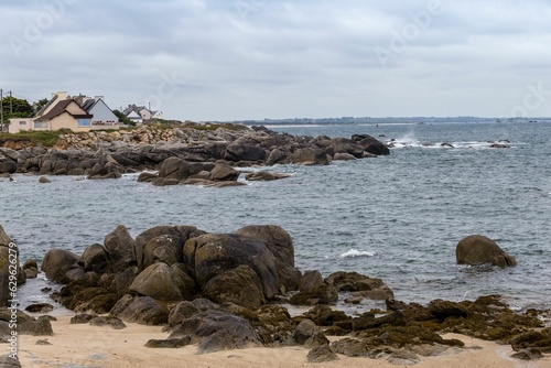 Landscape of a rocky shore surrounded by the sea on a cloudy day in Bretagne, France
