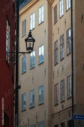 Vintage street lamp with old town buildings in the background.