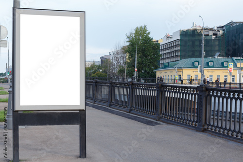 Vertical billboard for advertising and text in the city. Black steel railing. Mock-up.