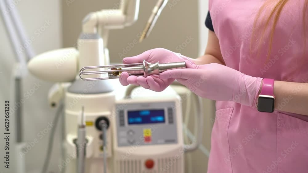 Closeup of the hands of a female doctor gynecologist in pink medical