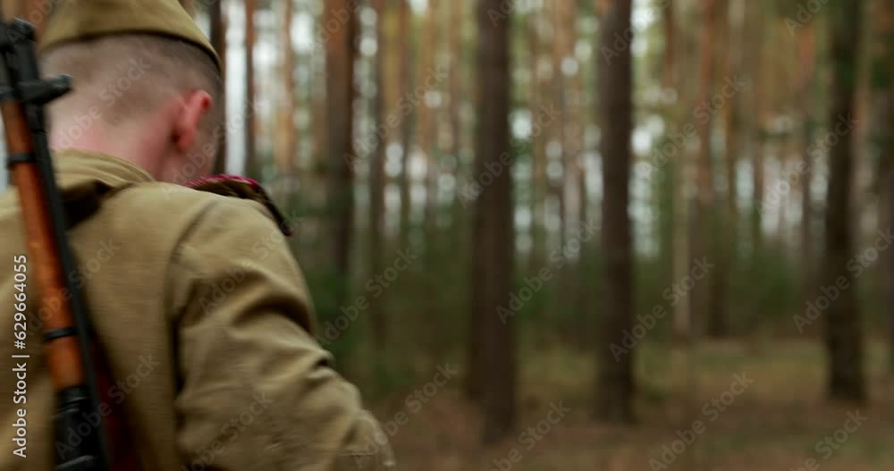 Re-enactors Dressed As Russian Soviet Infantry Red Army Soldiers Of World War II Marching Walking Along Forest Lane Road In Spring Autumn Day. Group of Soldiers Marching In Country Road. Re-enactors Dressed As Russian Soviet Infantry Red Army Soldiers Of World War II Marching Walking Along Forest Lane Road In Spring Autumn Day. Group of Soldiers Marching In Country Road.