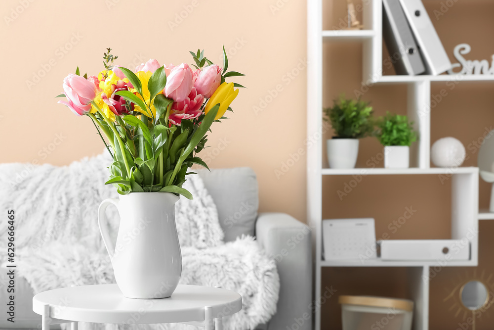Vase with spring flowers on table in living room Vase with spring flowers on table in living room