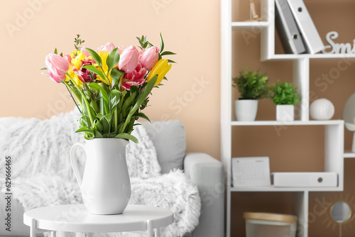 Vase with spring flowers on table in living room