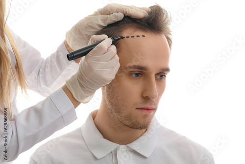 Doctor marking young man's ...
