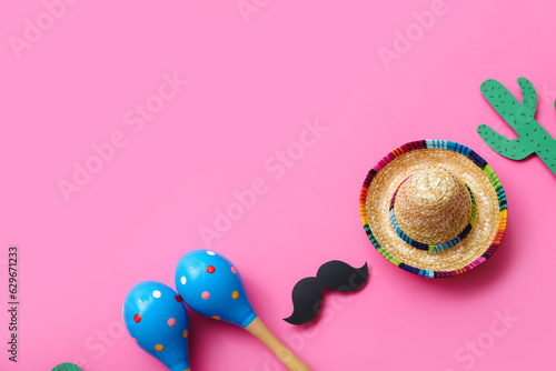 Mexican maracas with sombrero hat, paper mustache and cactus on pink background