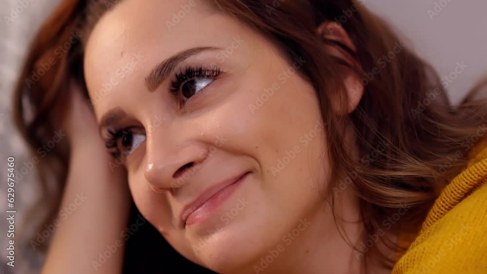 Thoughtful young woman - close up shot in slow motion Thoughtful young woman - close up shot in slow motion