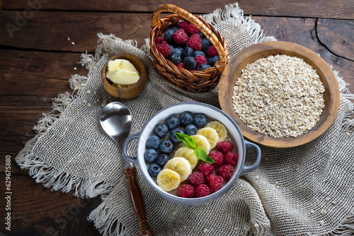  Healthy breakfast - oatmeal with banana, blueberries and raspberries.