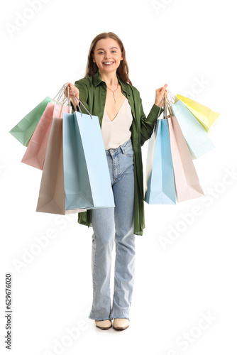 Young woman with shopping bags on white background