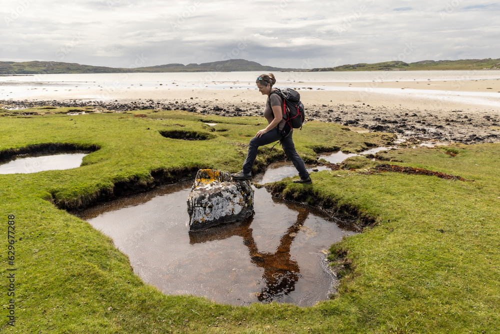 woman hiking on the isle of Colonsay in Scotland