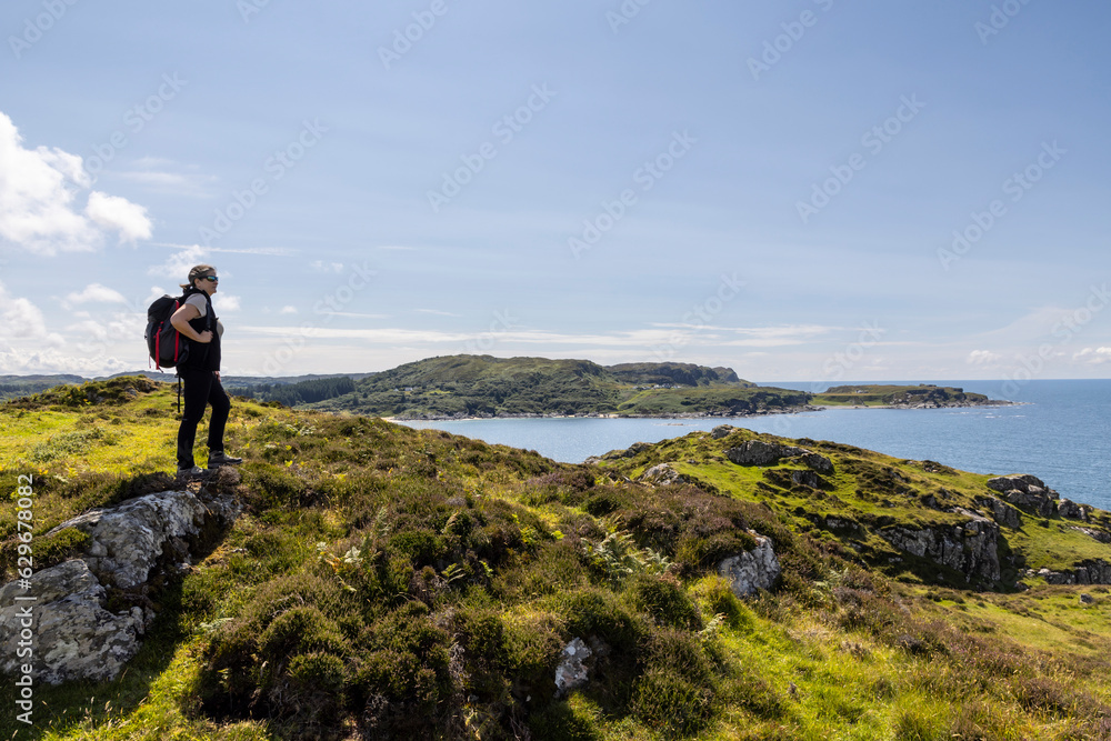 Woman hiking on the cliffs of Balnahard on the isle of Colonsay, Scotland