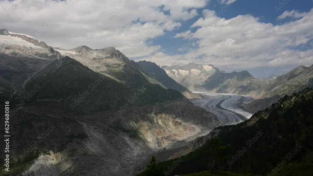 Landscape of glacier, mountain and forest. Time lapse of Aletsch Glacier in Swiss Alps. Riederalp, Valais Canton, Switzerland. Travel destinations. Ice melting. Landscape of glacier, mountain and forest. Time lapse of Aletsch Glacier in Swiss Alps. Riederalp, Valais Canton, Switzerland. Travel destinations. Ice melting.