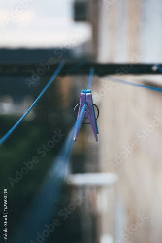 a clothespin hangs on a wire