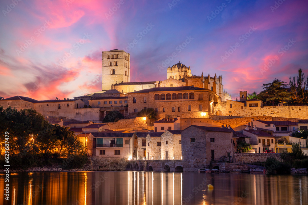 View at dusk of the old town of Zamora, Castilla y Len, Spain, with the cathedral on top and the Tormes river in the foreground