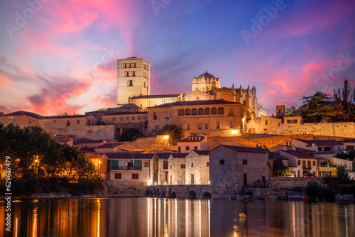 View at dusk of the old town of Zamora, Castilla y Len, Spain, with the cathedral on top and the Tormes river in the foreground