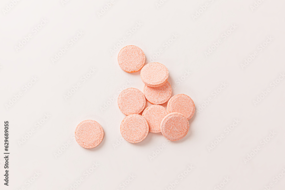 Yellow vitamin c tablet supplements isolated on a white background Yellow vitamin c tablet supplements isolated on a white background