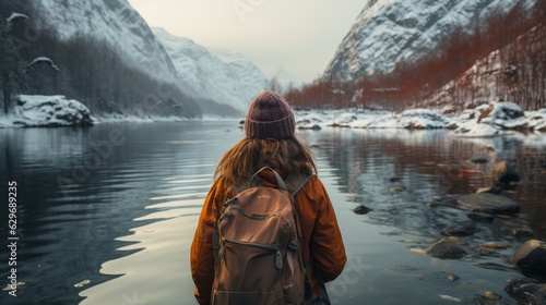 A beautiful woman stands near an icy lake. Generative AI