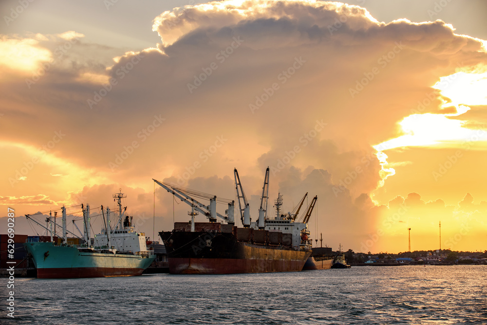 Cargo ship loading containers at sunshine