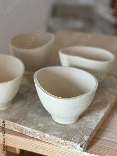 Handmade ceramic bowls in pottery workshop. Before burning. 