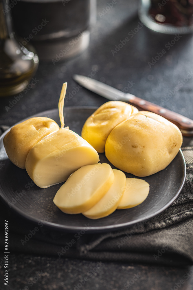 Smoked scamorza cheese on plate.