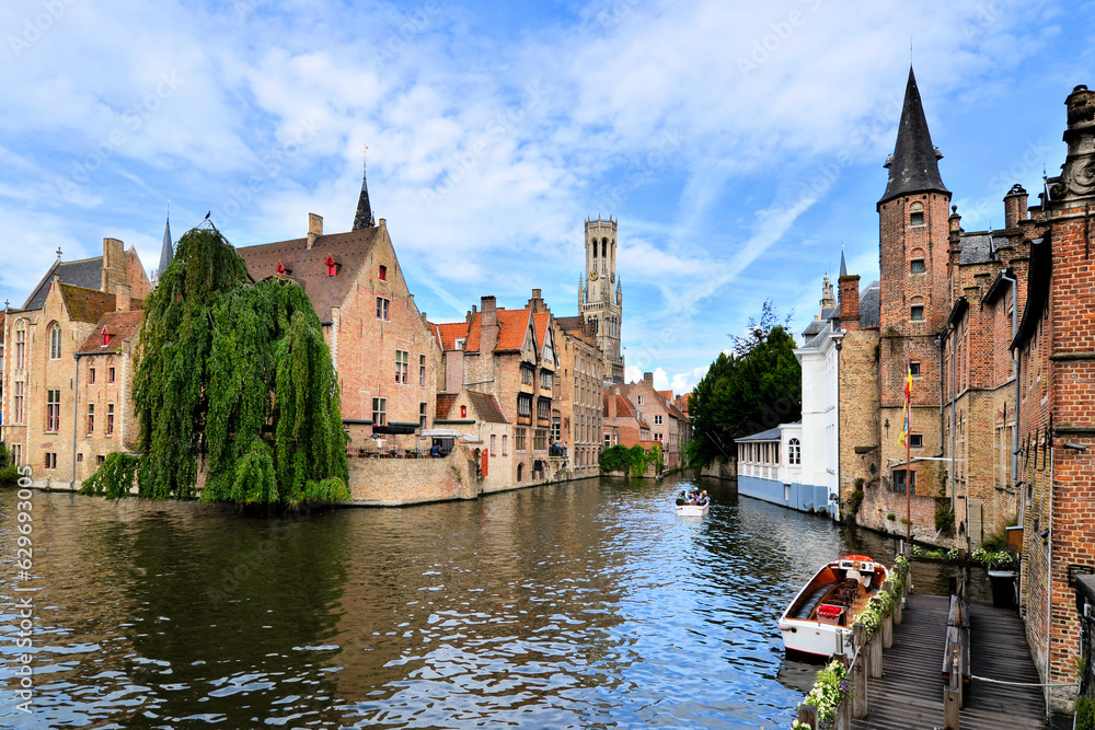 View of the medieval canals of Bruges, Belgium with famous bell tower View of the medieval canals of Bruges, Belgium with famous bell tower