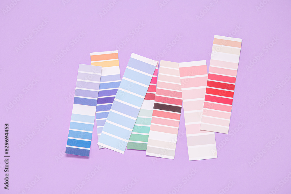 Many color palettes on lilac background, top view Many color palettes on lilac background, top view