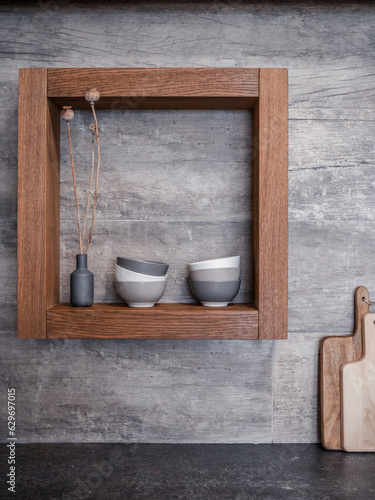 Kitchen wooden shelf with bowls and vase. MInimal design. Front view.