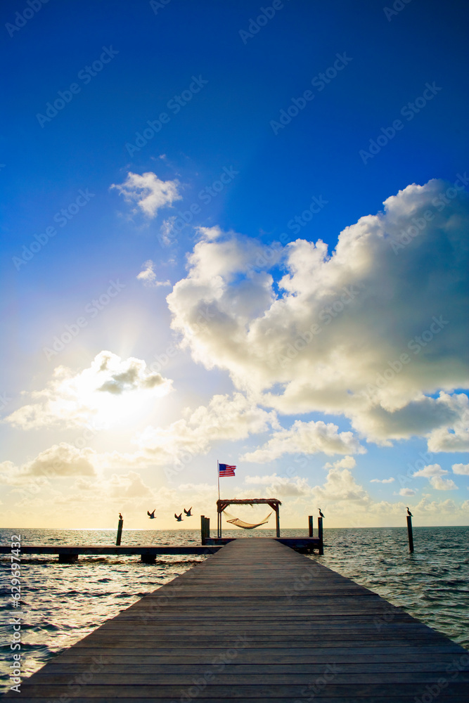 dock with American flag at the ocean