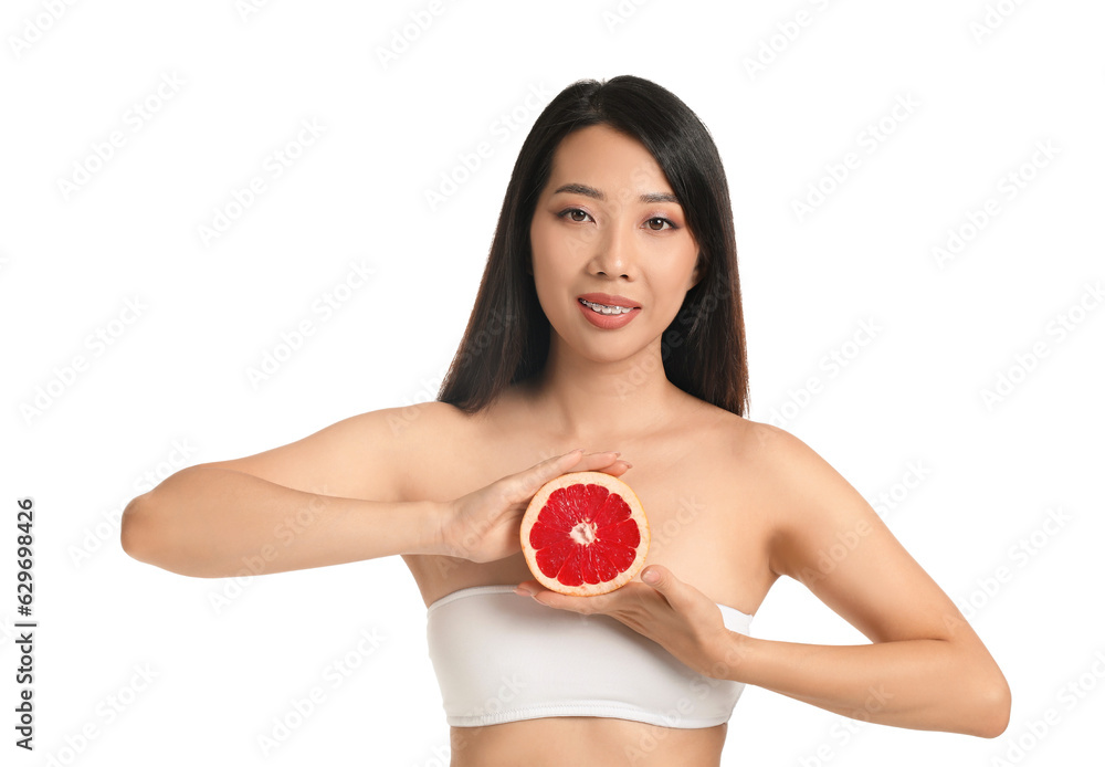 Beautiful young Asian woman with grapefruit on white background Beautiful young Asian woman with grapefruit on white background