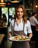 Young waitress presents a dish with Chicken Shawarma