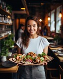 Young waitress presents a dish with Tacos - food photography