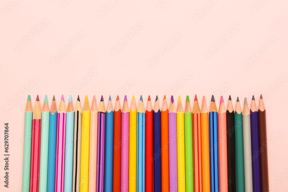 Color pencils on pink background, closeup Color pencils on pink background, closeup