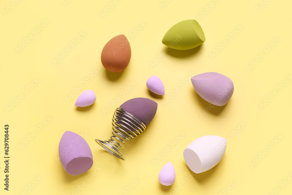 Obraz premium Different makeup sponges on yellow background