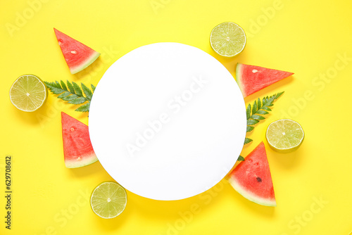 Blank card and pieces of fresh watermelon with lime on yellow background