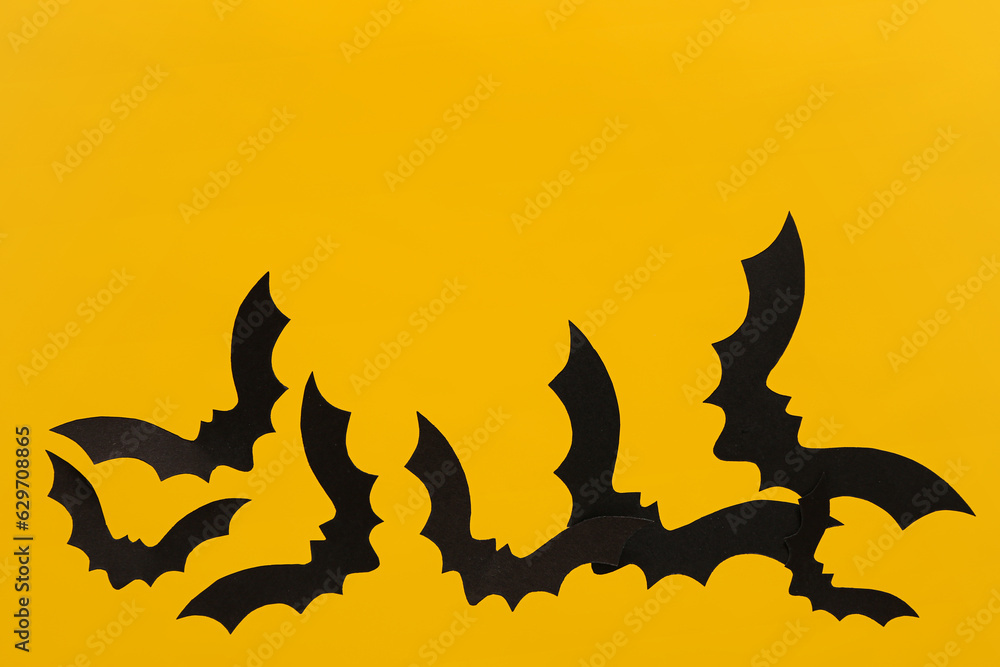 Paper bats for Halloween party on yellow background Paper bats for Halloween party on yellow background