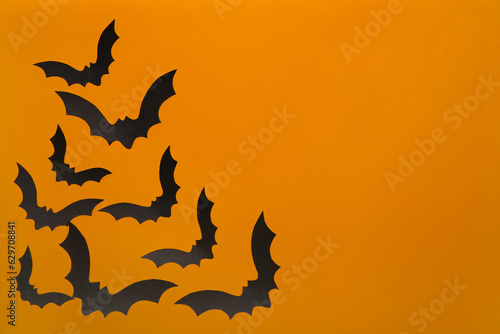 Paper bats for Halloween party on orange background © Pixel-Shot