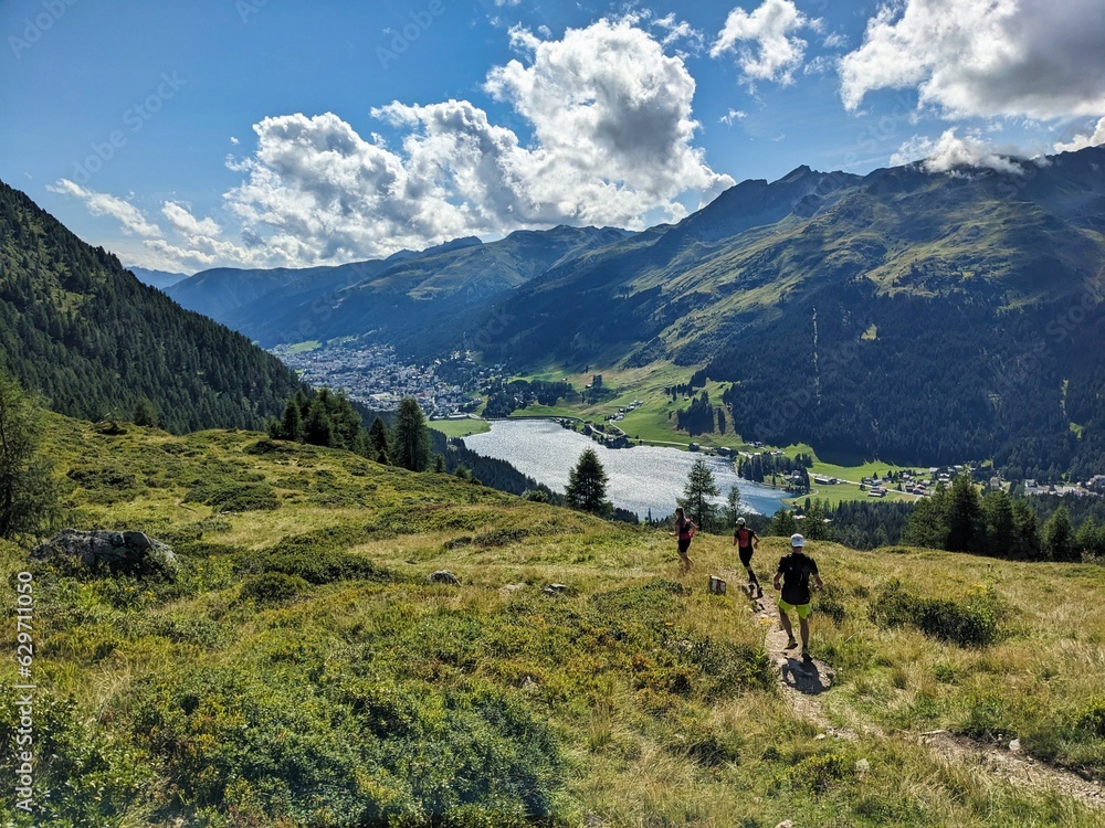 custom made wallpaper toronto digitalTrail running group runs down above Davos Klosters in the direction of Lake Davos. Running in the mountains. Beautiful trailrun landscape in Switzerland. High quality photo