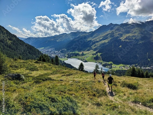 Wallpaper Mural Trail running group runs down above Davos Klosters in the direction of Lake Davos. Running in the mountains. Beautiful trailrun landscape in Switzerland. High quality photo Torontodigital.ca