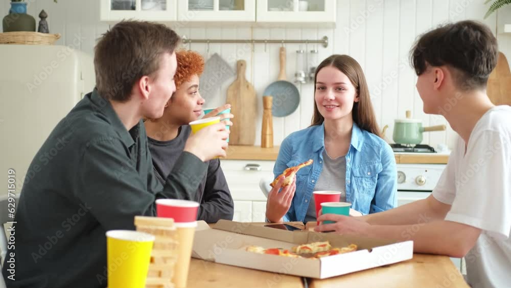 Home party. Friends spending time together having fun laughing communicating at home. Happy diverse group eating pizza drinking beer or lemonade. Mixed race young buddies best friends enjoying weekend Home party. Friends spending time together having fun laughing communicating at home. Happy diverse group eating pizza drinking beer or lemonade. Mixed race young buddies best friends enjoying weekend