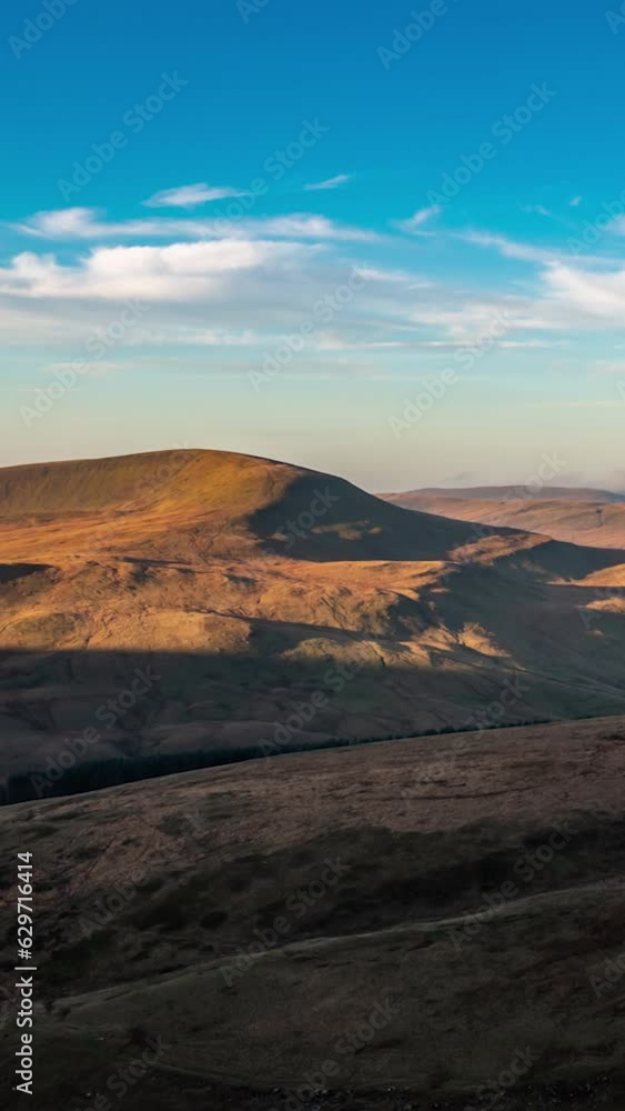 Time Lapse of Brecon Beacons National Park in Wales. Time lapse of vibrant landscape with hills and flying cloudscape at blue sky. Brecon Beacons National Park, Wales. Aerial vertical, vertical video. Time Lapse of Brecon Beacons National Park in Wales. Time lapse of vibrant landscape with hills and flying cloudscape at blue sky. Brecon Beacons National Park, Wales. Aerial vertical, vertical video.