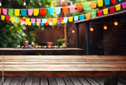Empty wooden table with Mexican fiesta background out of focus