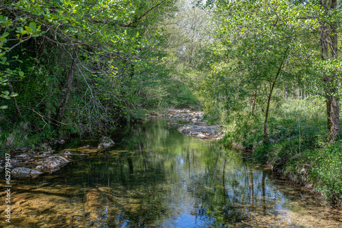 muga river that runs between the rocks and trees in san lorenzo de la muga girona spain