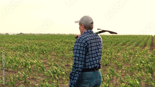 farmer shovel corn field, work field with shovel, smile face portrait farmer, farming shovel, rubber tillage farmland fertile growing farm soil business dust agronomist grass field gardener spade © Валерий Зотьев